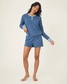 A woman wearing blue polka dot floral shorts