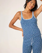 Woman wearing a blue polka dot white flower tank top and shorts