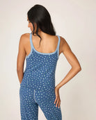 Woman wearing a blue polka dot white flower tank top and shorts