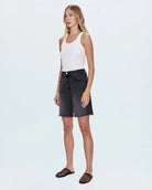 woman wearing black denim shorts
