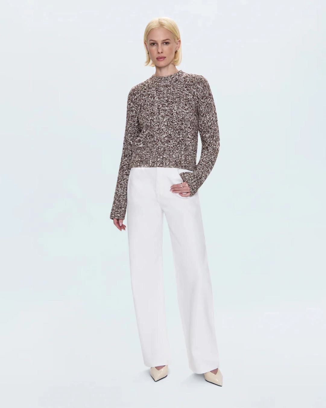 a woman wearing a cable knit fisherman sweater by Pistola 