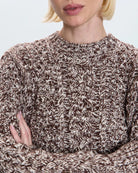 a woman wearing a cable knit fisherman sweater by Pistola 