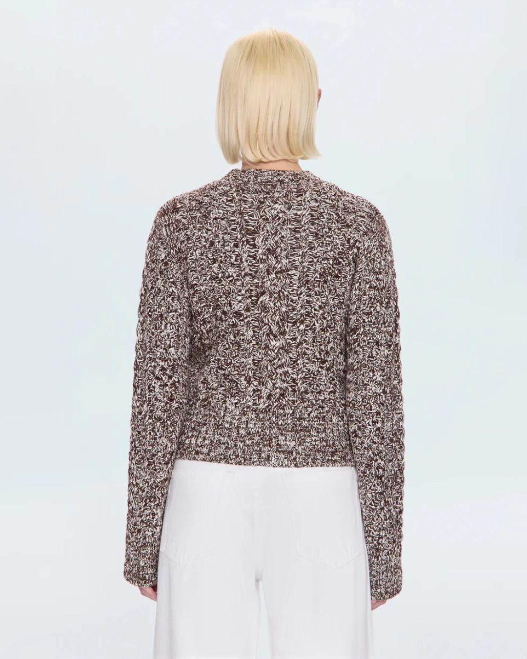a woman wearing a cable knit fisherman sweater by Pistola 
