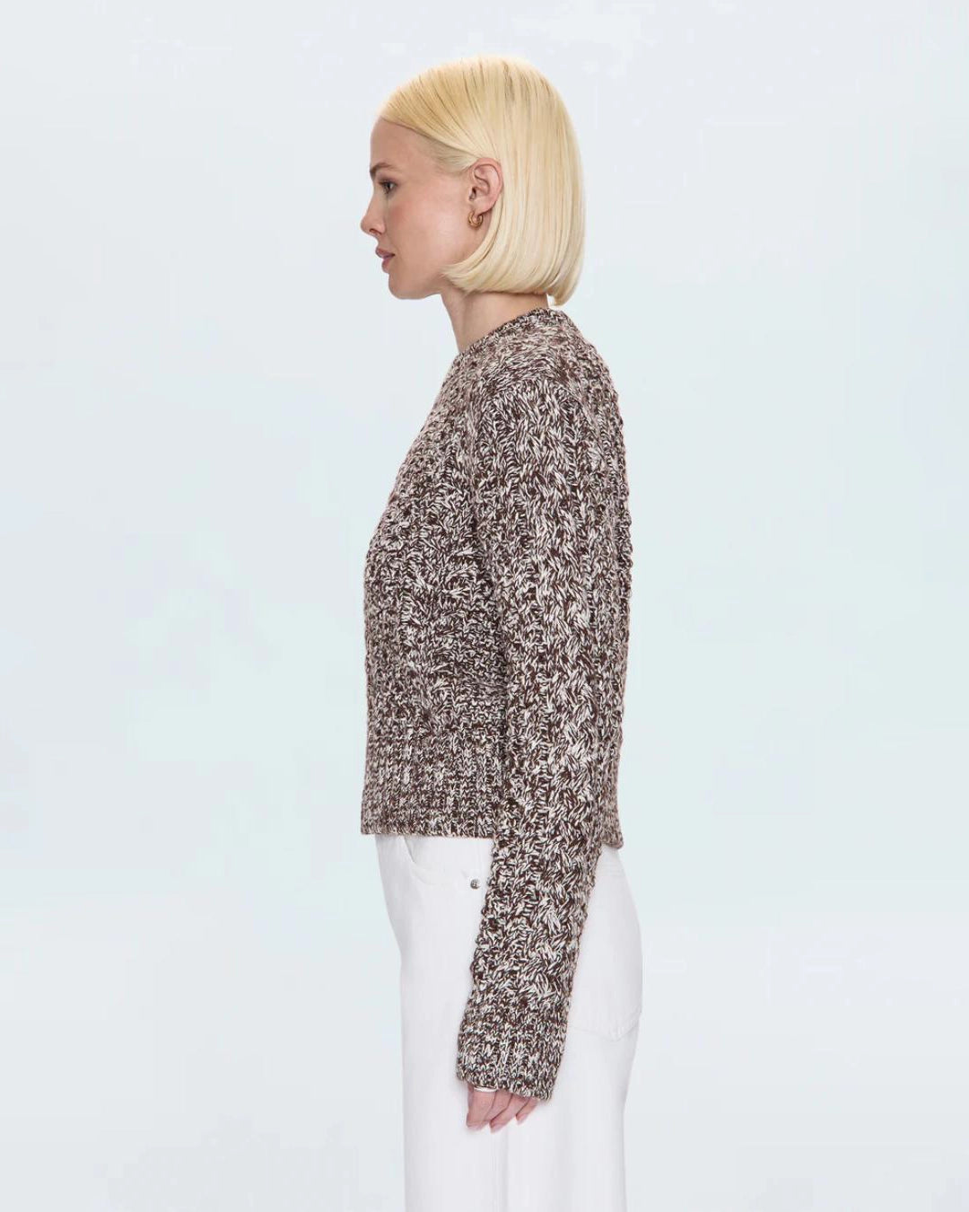 a woman wearing a cable knit fisherman sweater by Pistola 