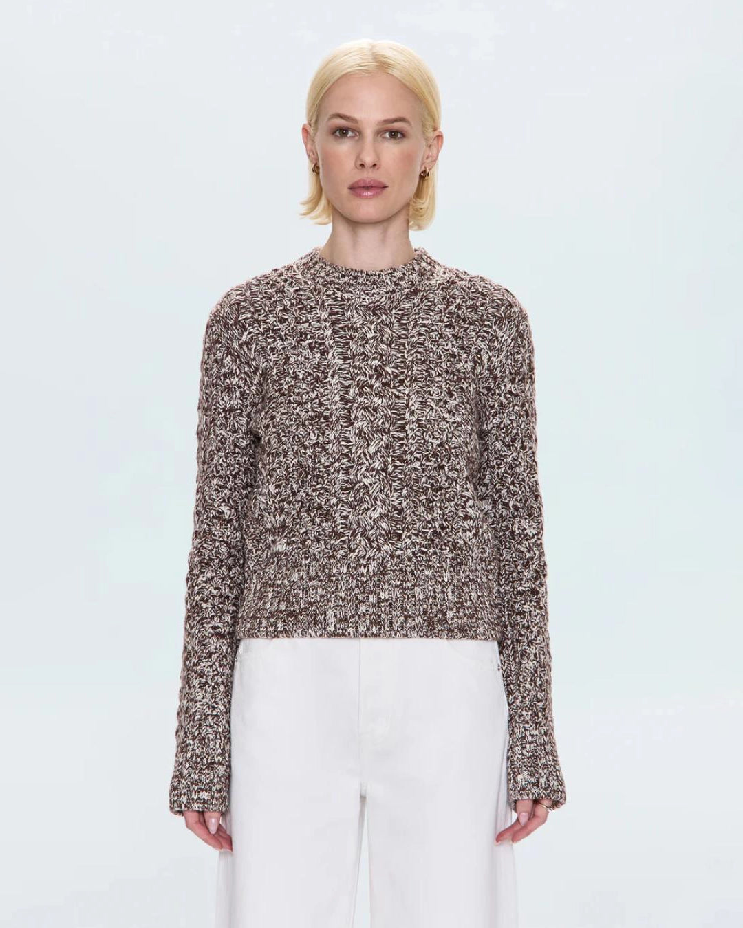 a woman wearing a cable knit fisherman sweater by Pistola 
