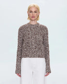 a woman wearing a cable knit fisherman sweater by Pistola 