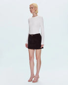 A woman wearing a brown corduroy skirt