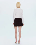 A woman wearing a brown corduroy skirt