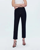 a woman wearing cropped dark wash ankle denim jeans by Pistola