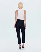 a woman wearing cropped dark wash ankle denim jeans by Pistola
