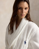 a short cotton terry bathrobe with the polo ralph lauren logo on the chest and a large bear embroidered on the back