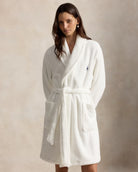 a short cotton terry bathrobe with the polo ralph lauren logo on the chest and a large bear embroidered on the back