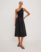 a woman wears an asymmetrical one shoulder dress in black