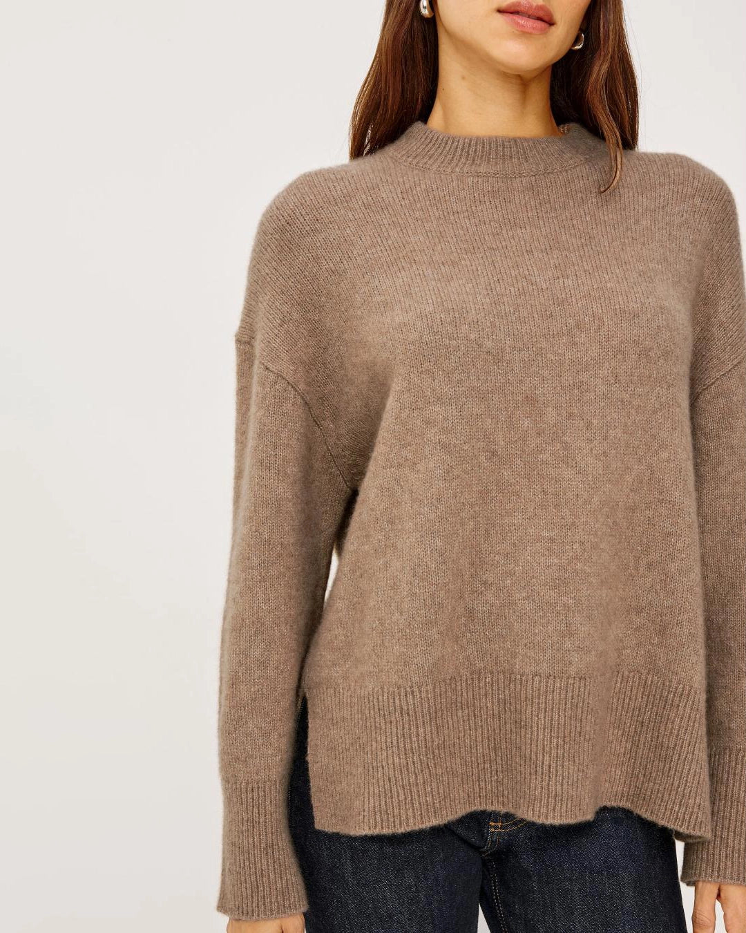 a woman wears a brown cashmere sweater 