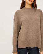 a woman wears a brown cashmere sweater 