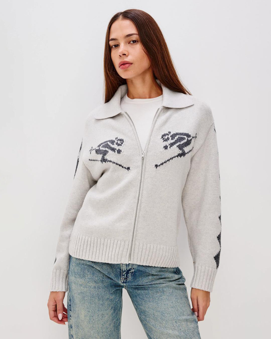 Grey zip up sweater with two skiiers on the chest in blue