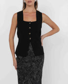woman wearing knit button down vest in black