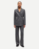 Person wearing a gray pinstripe suit