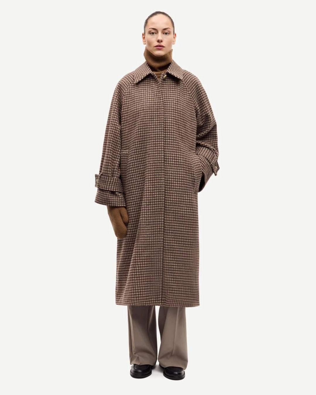 a woman wearing a long brown checked coat by Samsoe Samsoe