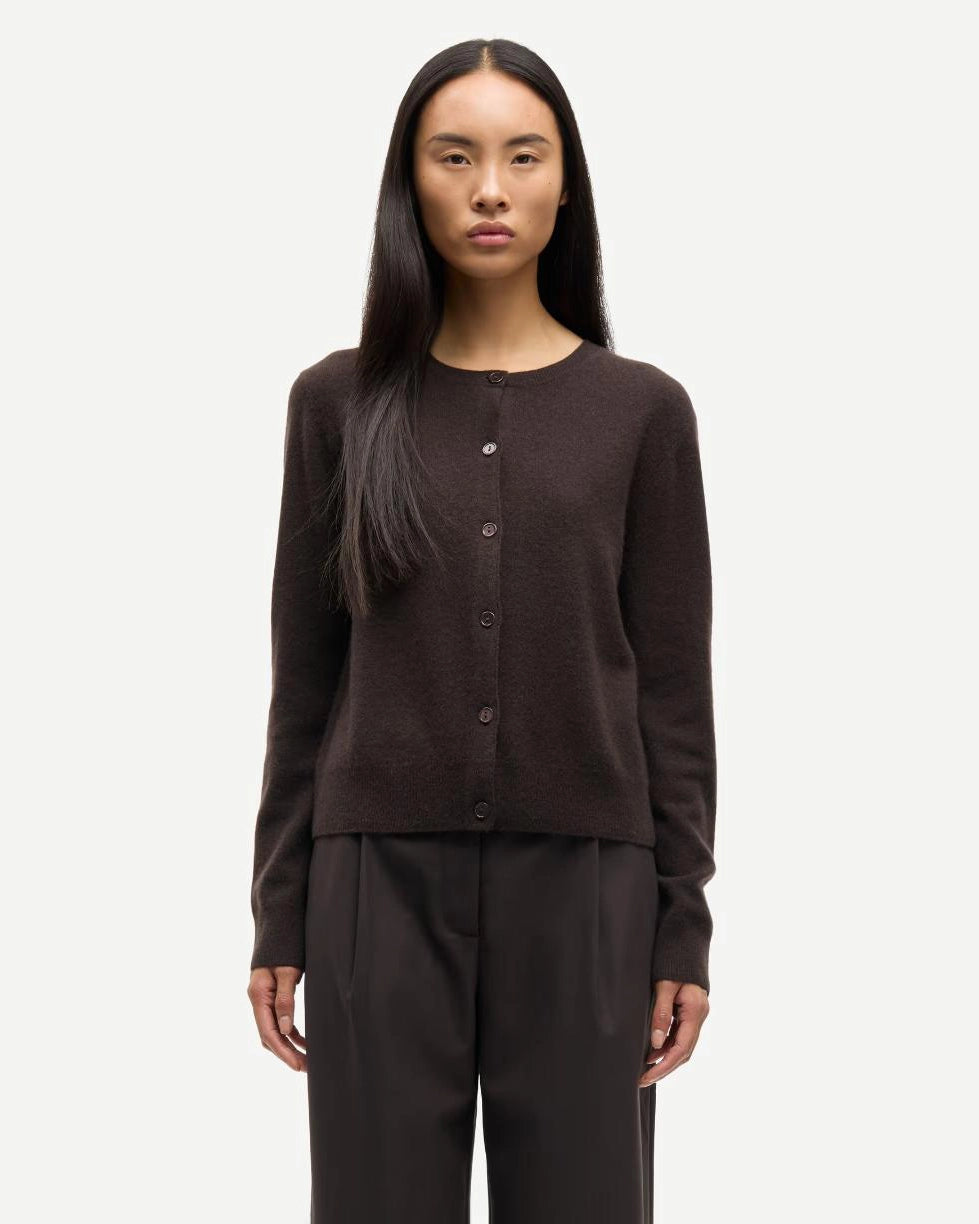 Woman wearing a brown button-up cashmere cardigan by Samsoe Samsoe