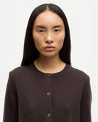 Woman wearing a brown button-up cashmere cardigan by Samsoe Samsoe