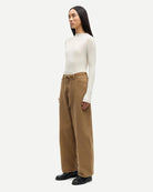 a woman wearing 100% cotton jeans with belt in khaki colour