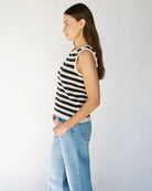 Woman wearing a crochet knit black and white striped sleeveless top 