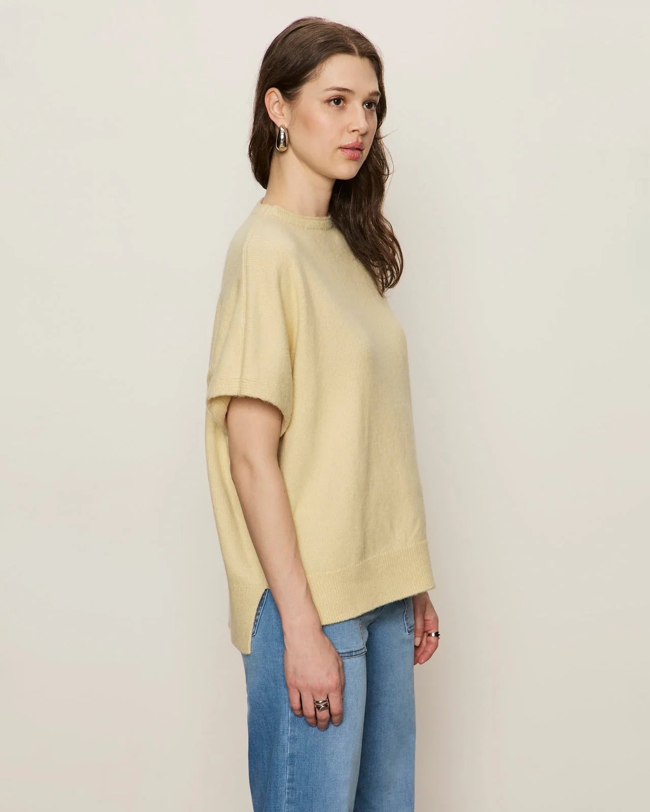 Woman wearing a light yellow oversized cashmere tee sweater