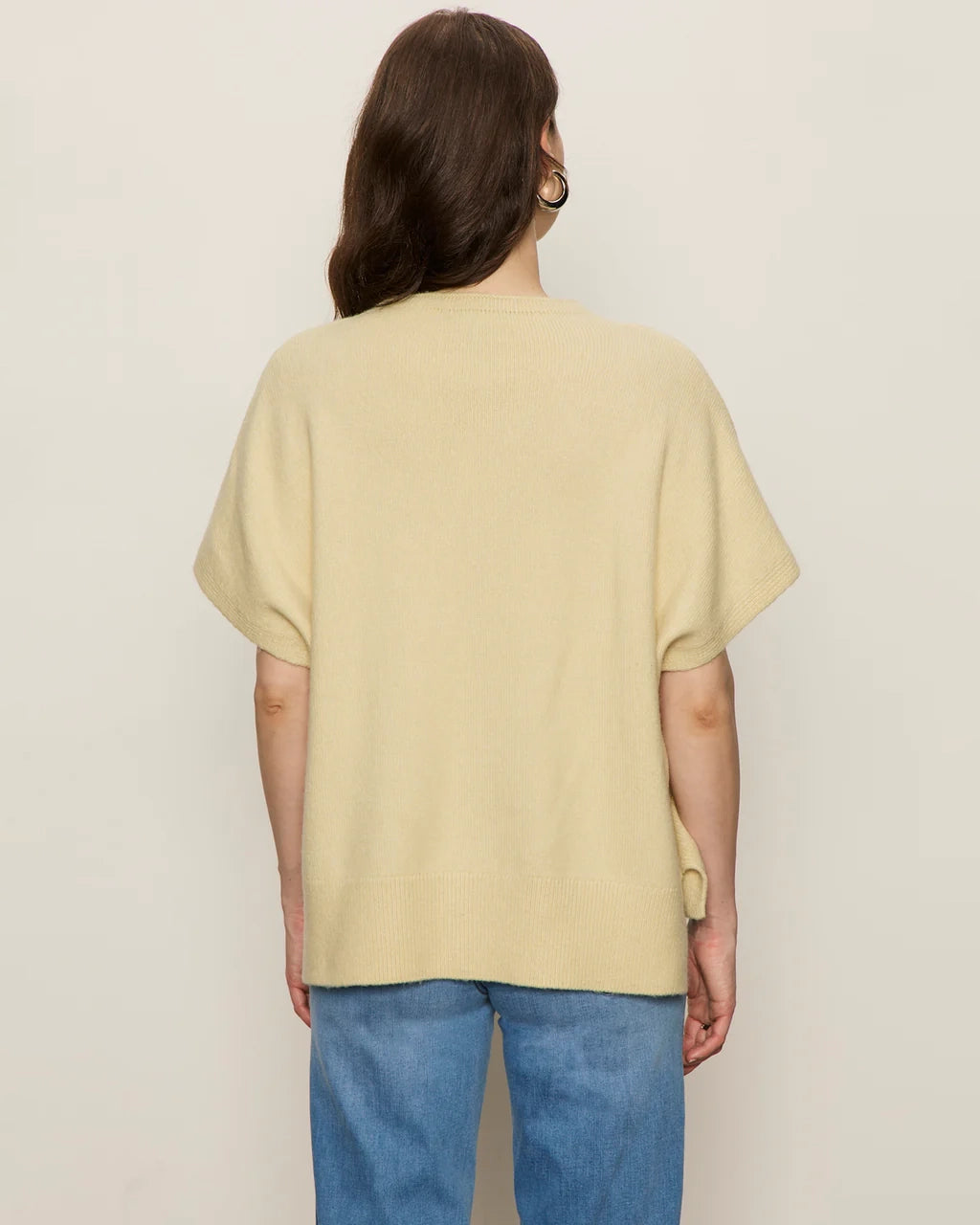 Woman wearing a light yellow oversized cashmere tee sweater