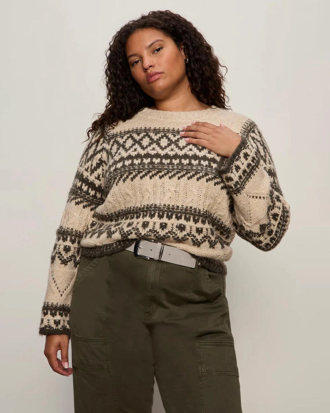 woman wearing a fairisle sweater in khaki green and cream