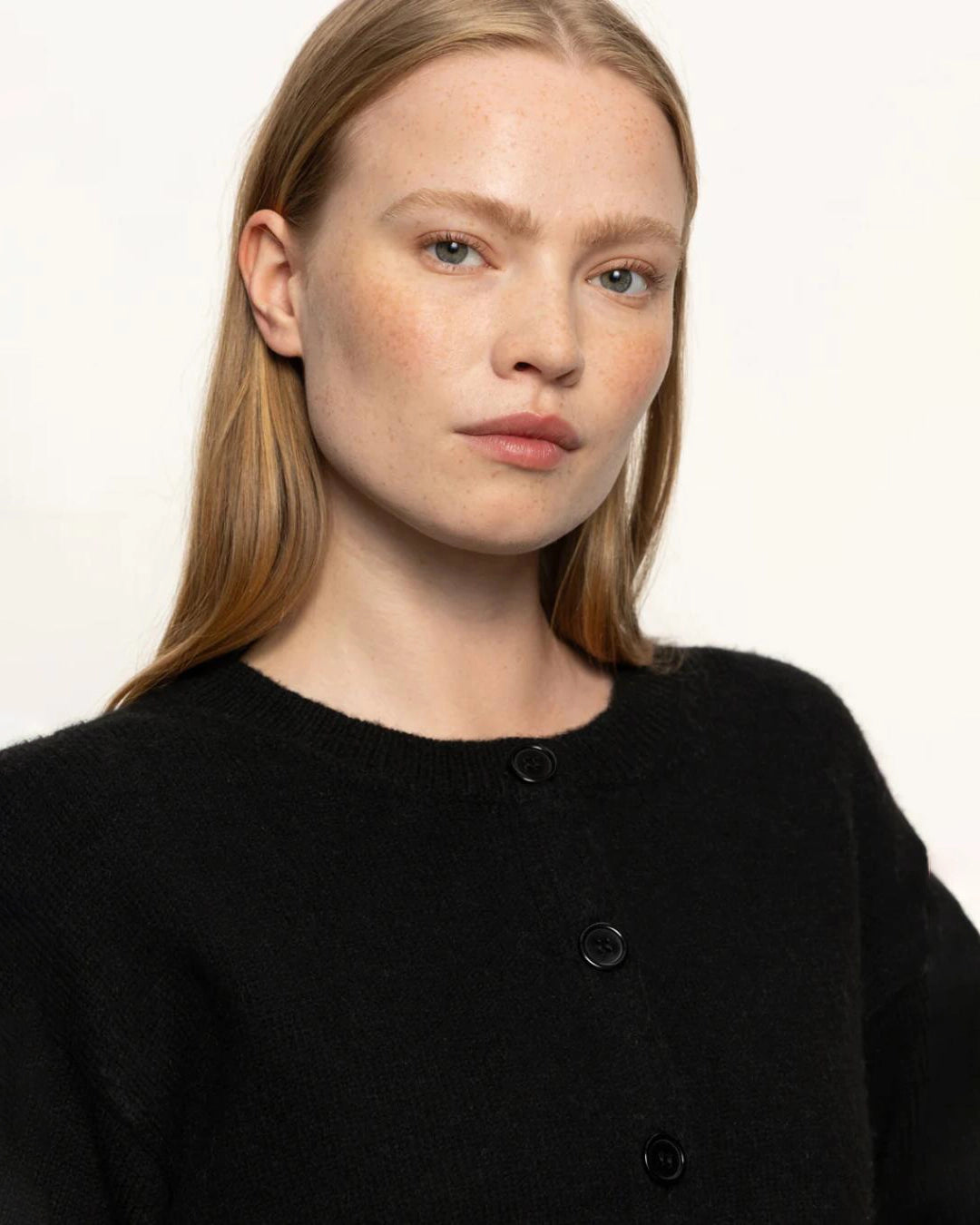 Woman wearing a black button down cardigan