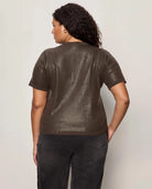 Woman wearing a sequin textured tshirt sweater in brown