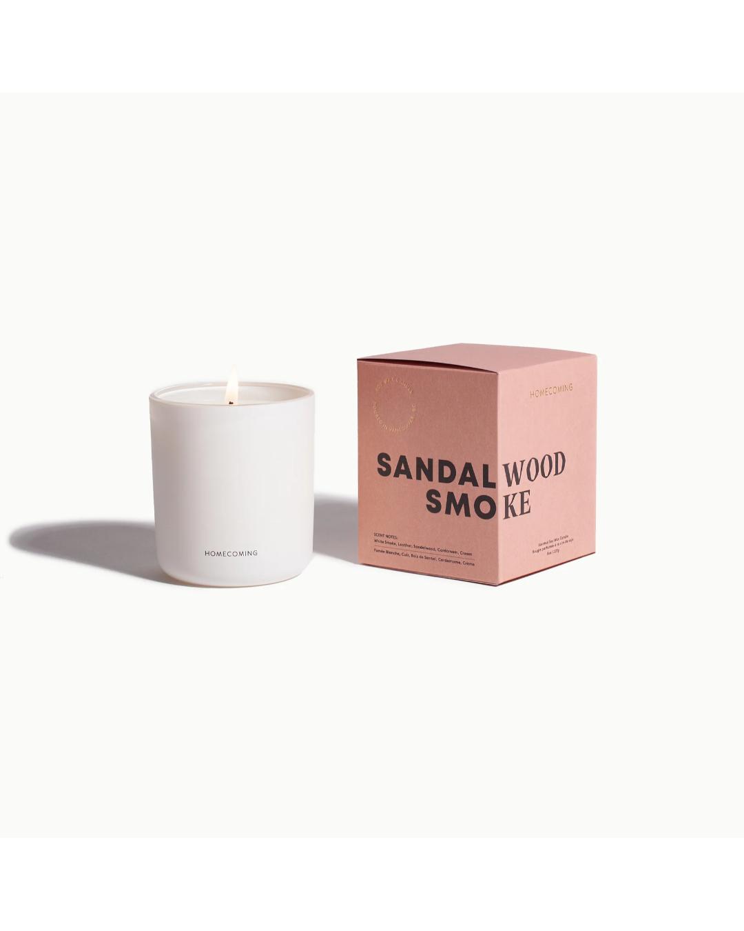 white candle beside pink box