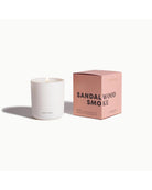 white candle beside pink box