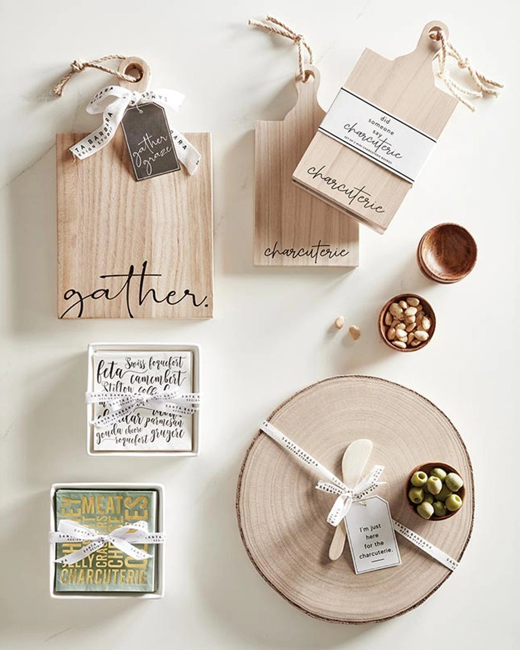 spread of entertainment hostess gifts including wooden pinch bowls and charcuterie boards