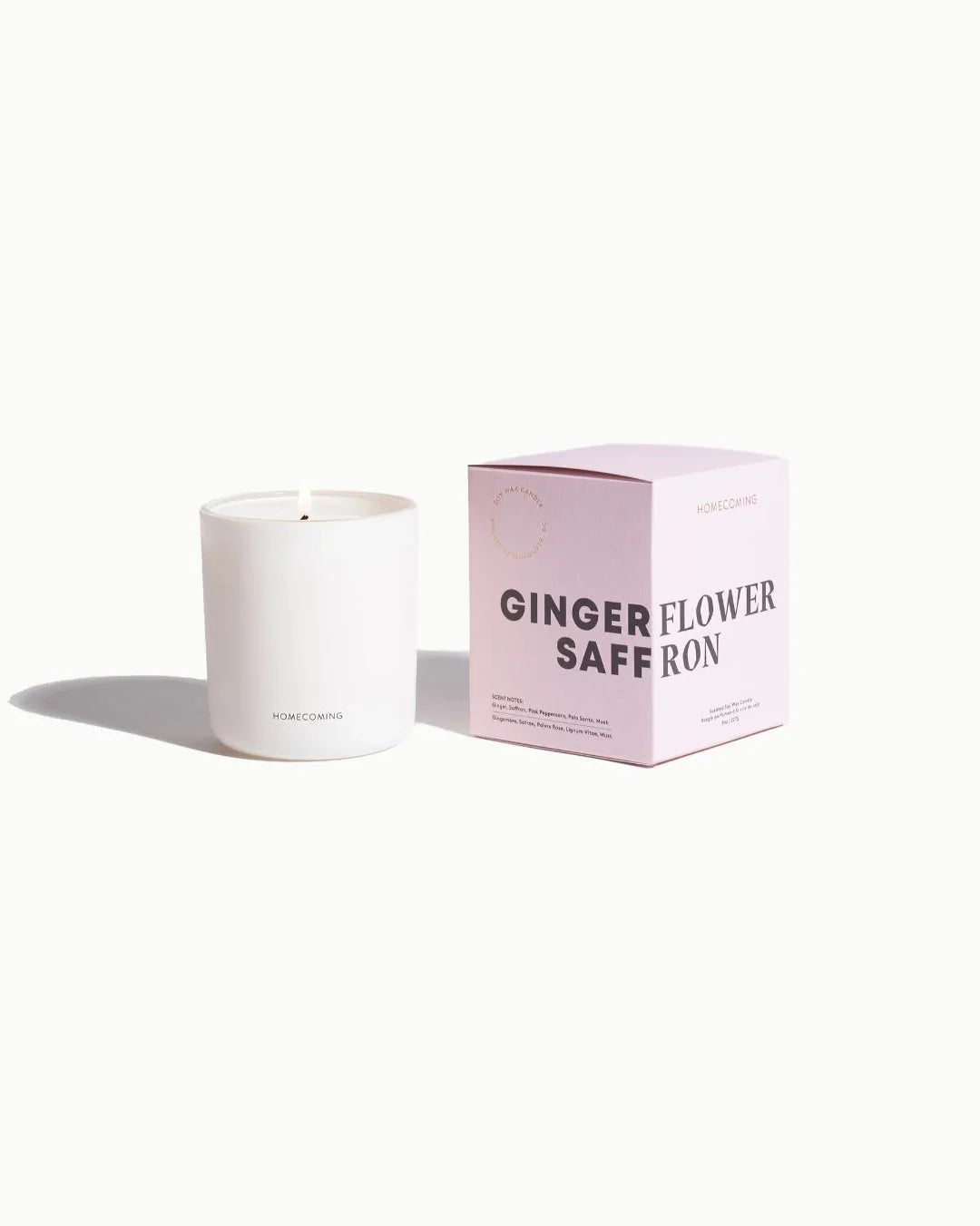 a white candle with pink box  with 'Gingerflower Saffron' written on it