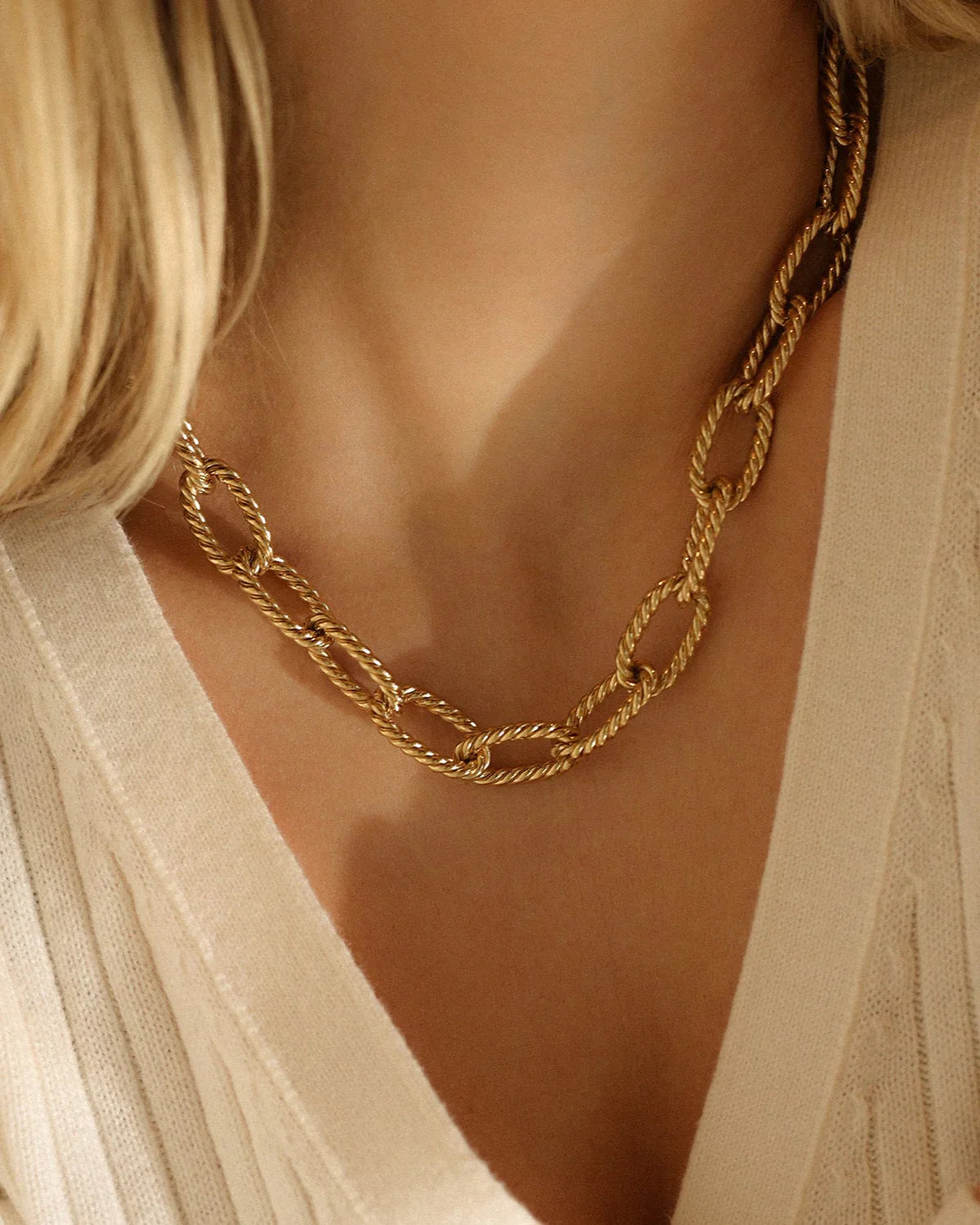 A gold knotted chain link necklace