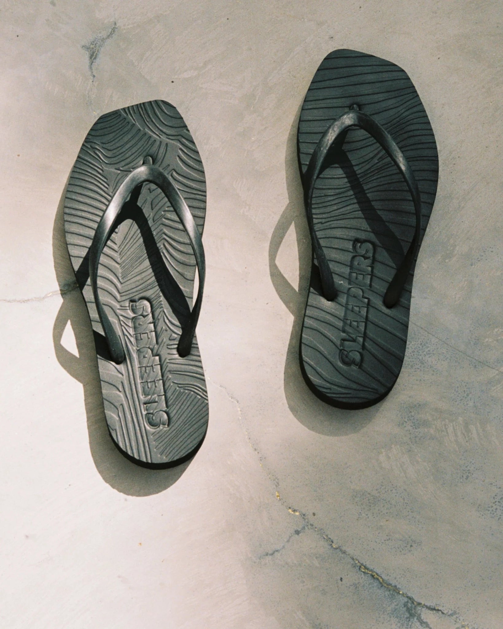 Pair of black flip-flop sandals by Sleepers