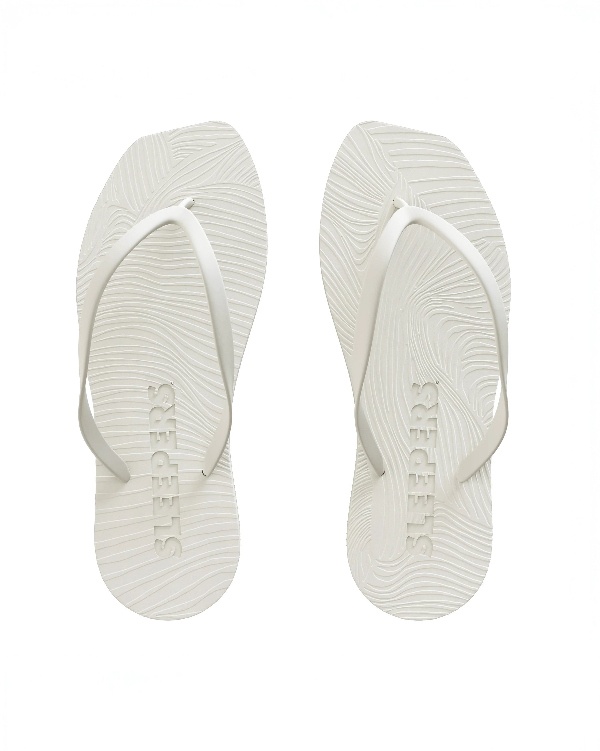 Pair of white flip-flop sandals by Sleepers with logo on the bottom