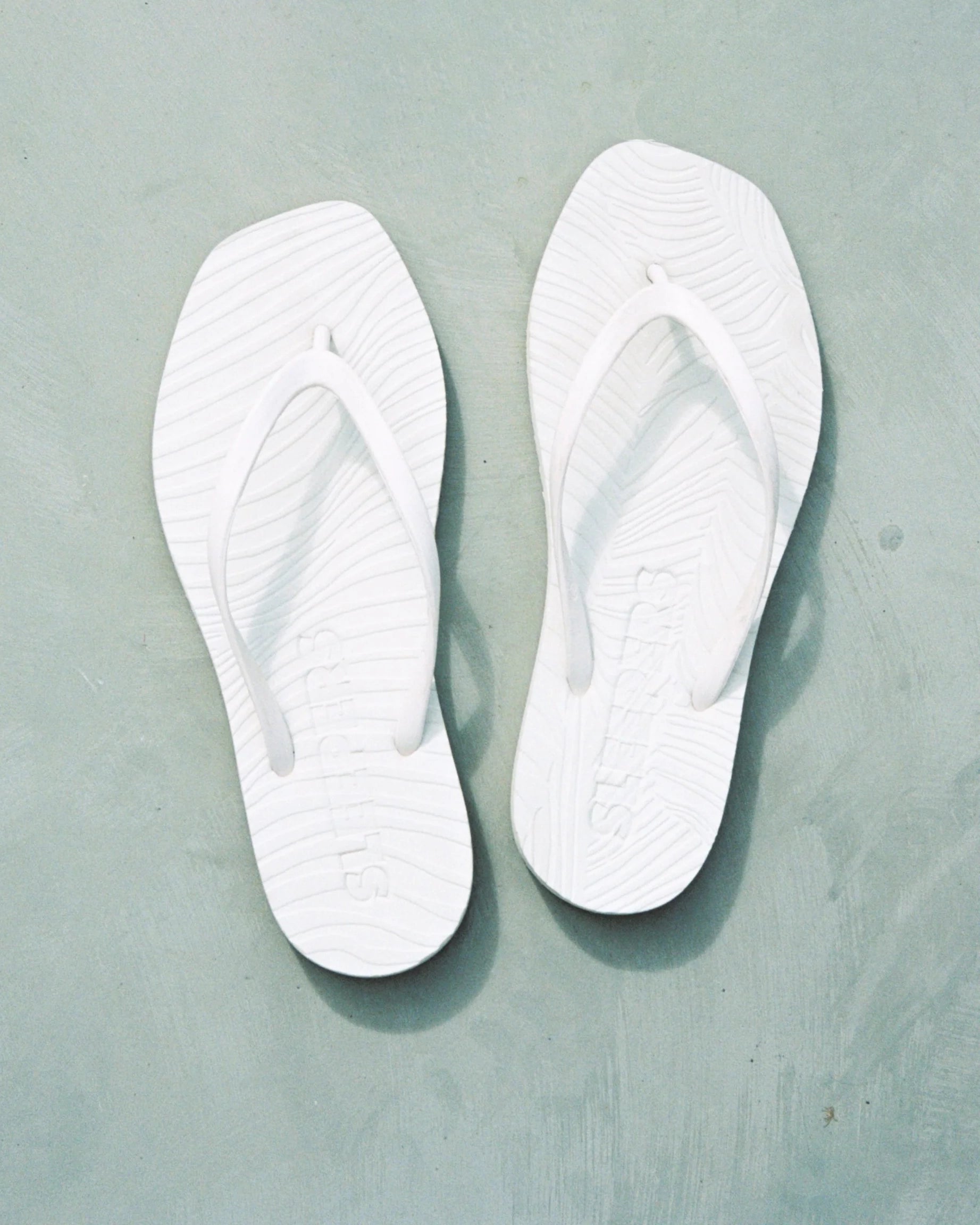 Pair of white flip-flop sandals by Sleepers