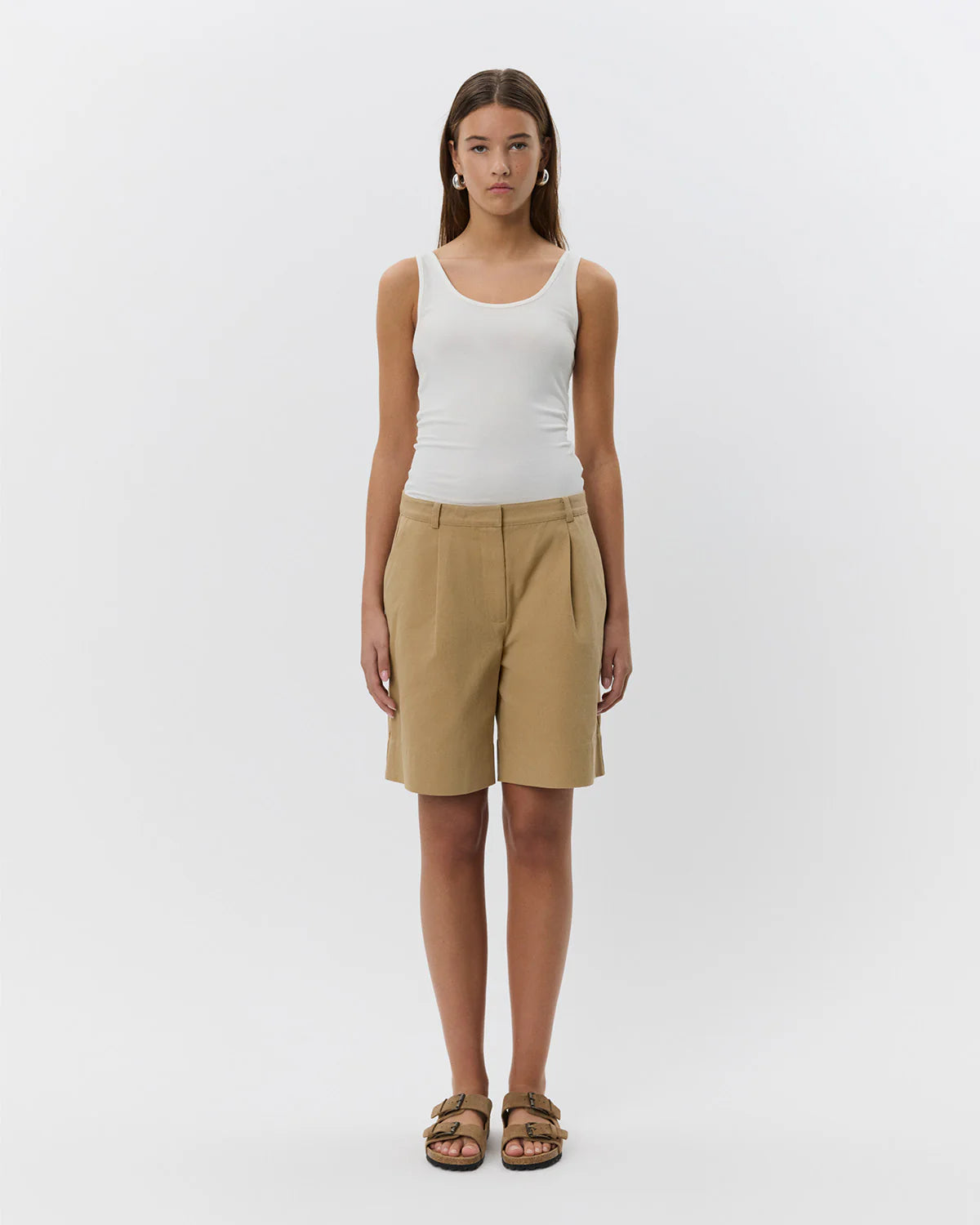 woman wearing camel khaki knee length shorts 