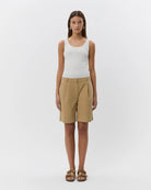 woman wearing camel khaki knee length shorts 