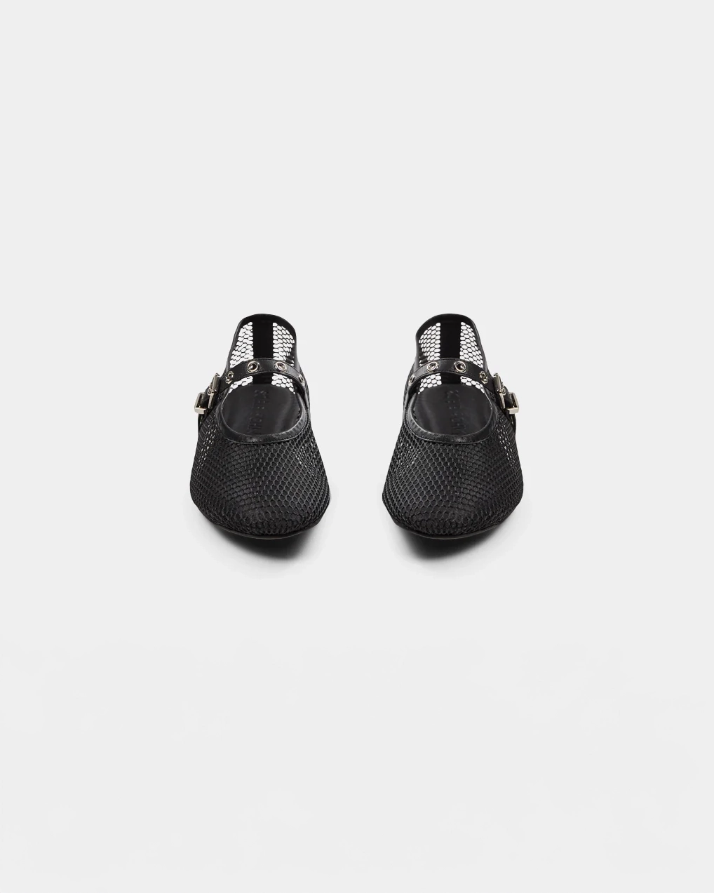a black ballerina flat that is mesh and has a strap going across the foot with meal holes and a buckle