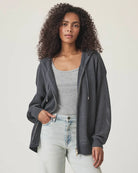 Woman wearing a netted gray zip up cardigan 