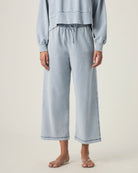 person wearing light blue grey terry pants with drawstring and elastic waistband
