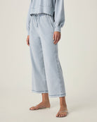 person wearing light blue grey terry pants with drawstring and elastic waistband