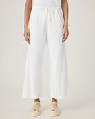 woman wearing white wide-leg terry cloth drawstring pants 