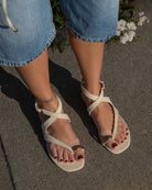 Beige ecru suede sandal with thin straps and gold toe detail