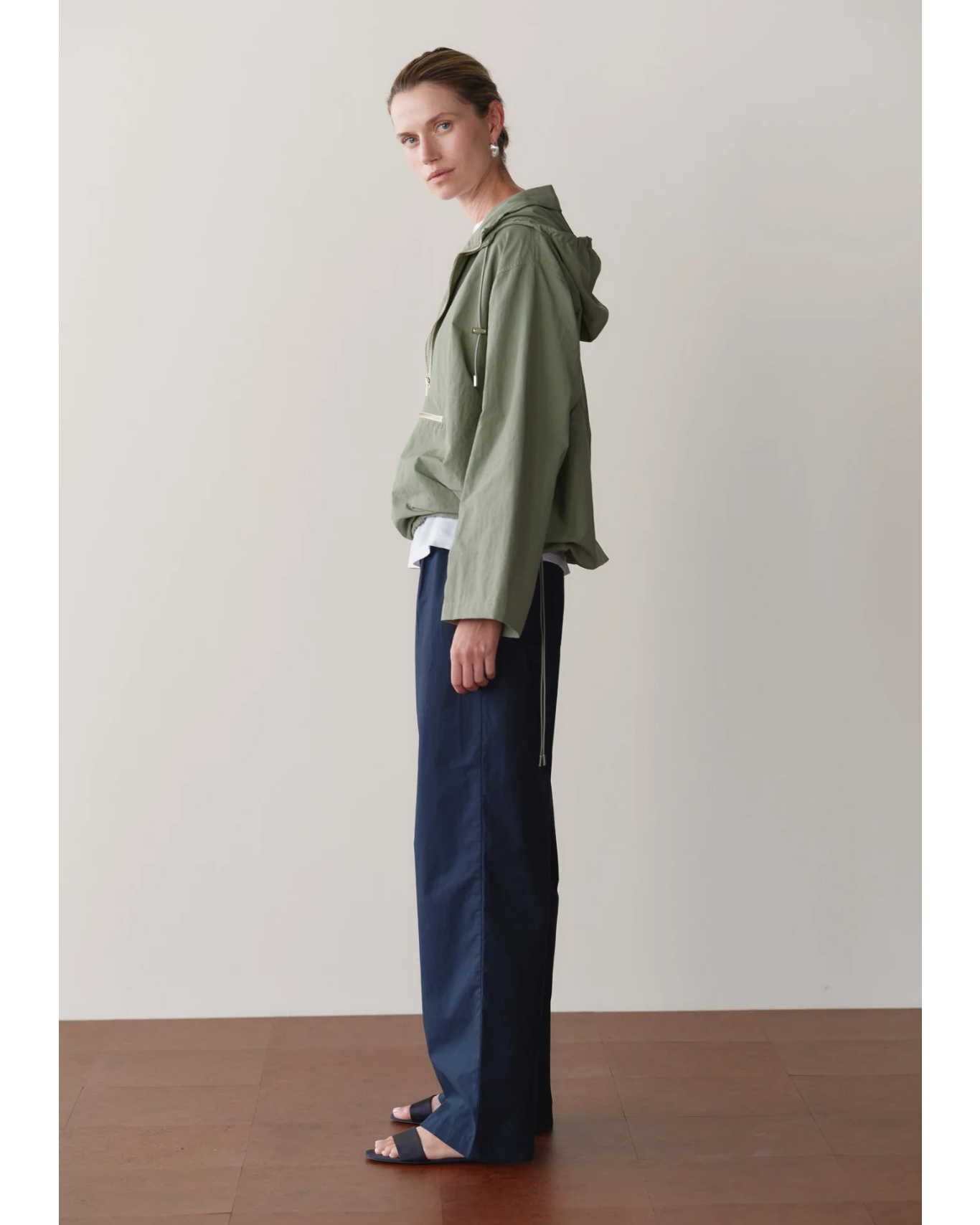 green rain jacket with wide sleeves and a hood