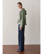 green rain jacket with wide sleeves and a hood